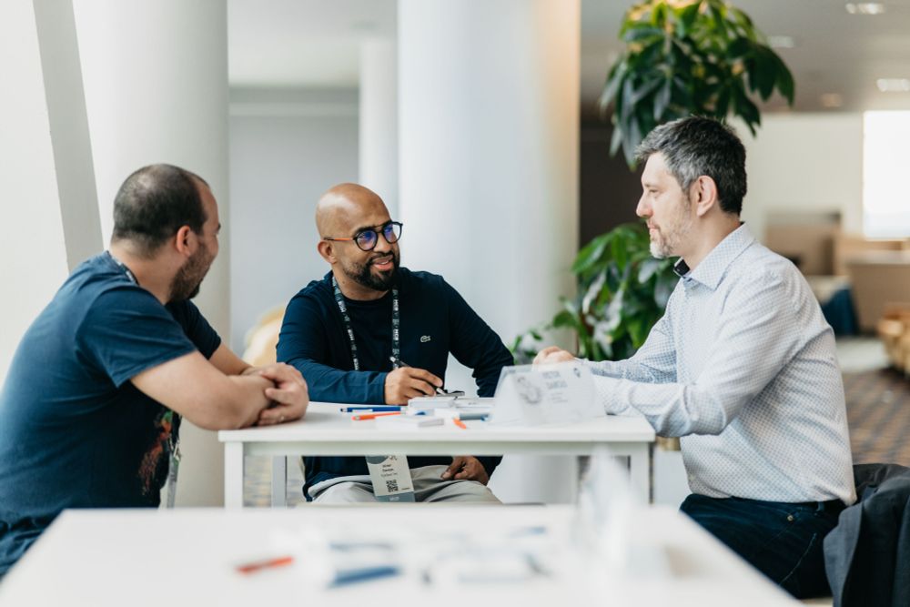 Raphael Pothin with friends around a table at DynamicsMinds 2025