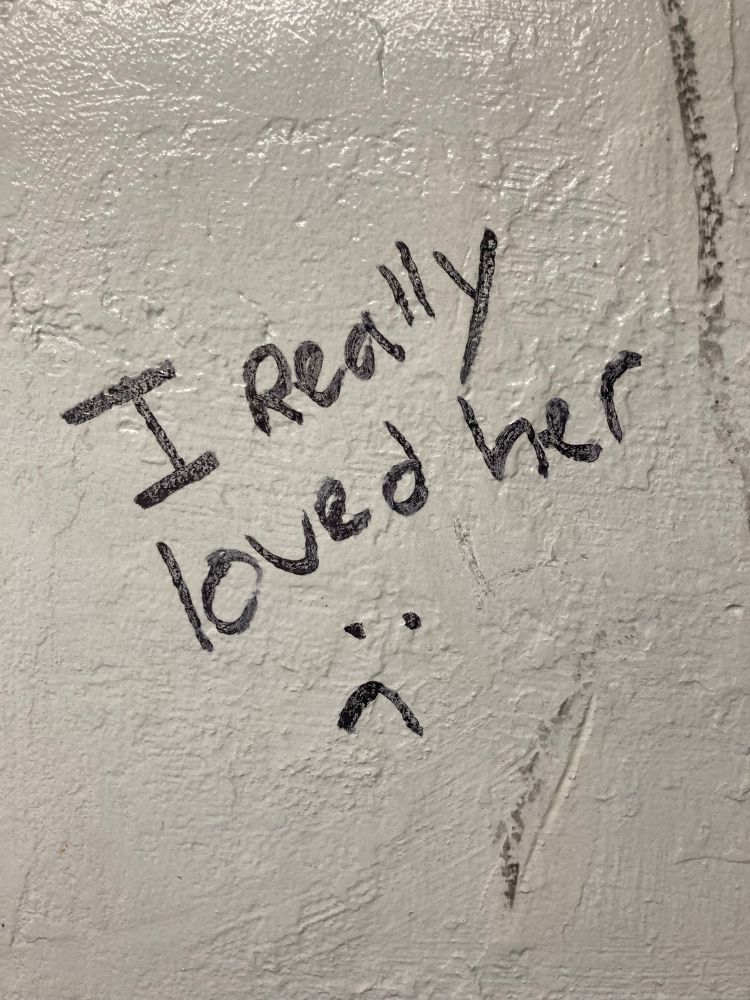 Graffiti on Amtrak boarding station wall “I really loved her :(“