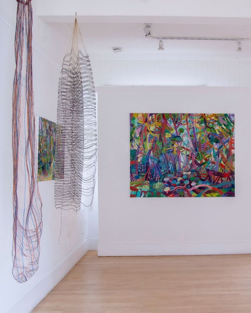 From left to right 
1. MICHELLE YI MARTIN, “Copper Holloway,” 2024, copper, cotton, 74 h x 11 inches, courtesy of the artist.
2. MICHELLE YI MARTIN, “Nightshape,” 2025, monofilament, silk, wool, 61 x 15 inches, courtesy of the artist.
3. JOHANNA ST. CLAIR, “The Clearing,” 2025, oil on canvas, 38 x 60 inches, courtesy of Gallery 16
