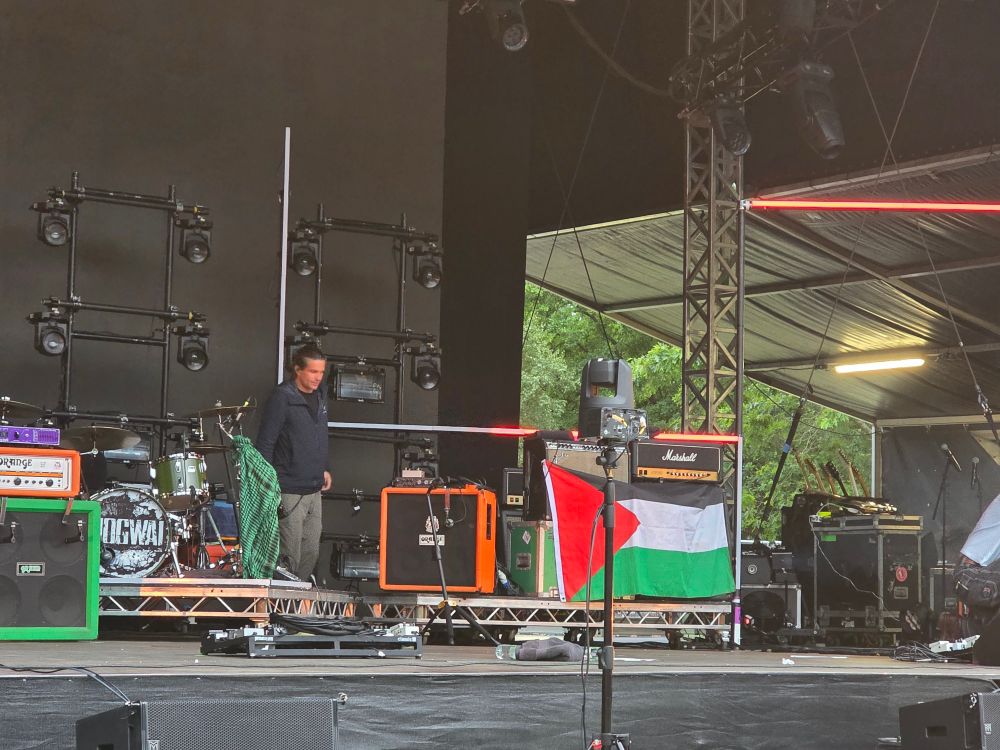 A Palestinian flag on an amp on stage. 