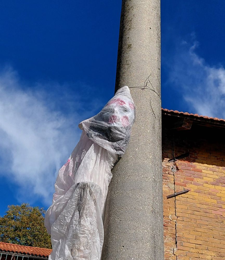 An Halloween puppet hanging from a pole
