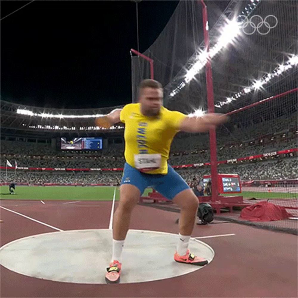 a man in a yellow shirt is throwing a discus at the olympics