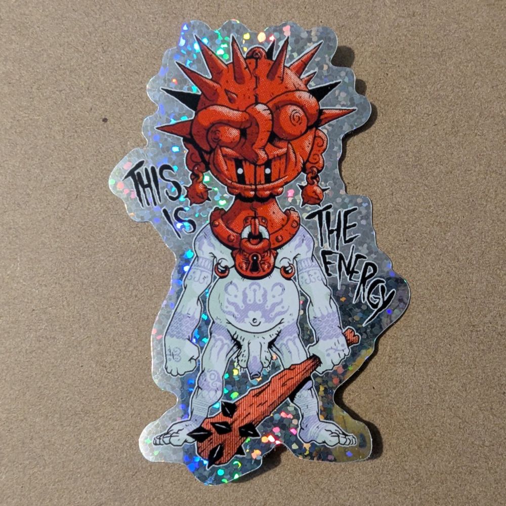 A sticker of a buck naked guy with a large mask on his head. Text says THIS IS THE ENERGY