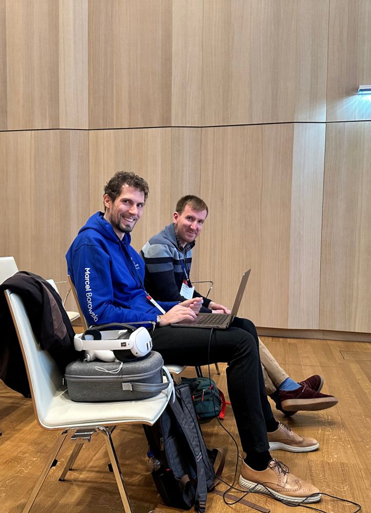 Marcel in a blue hoodie and Pete in a striped sweater getting ready to present DashSpace at IEEE VIS 2025 in Vienna.