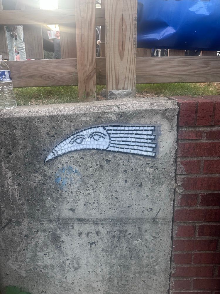 A tile mural of some thing with eyes