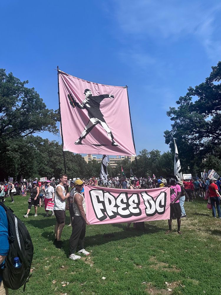 A sign of a man throwing a sandwich with a free dc banner underneath 