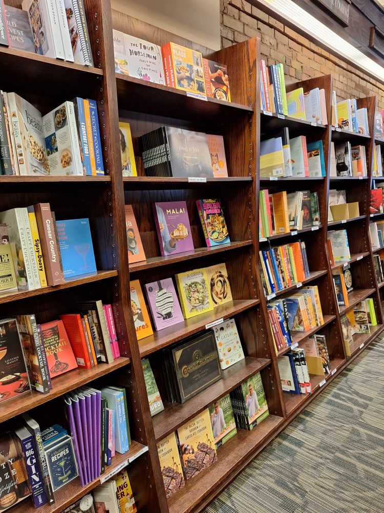A set of shelves full of more cookbooks.