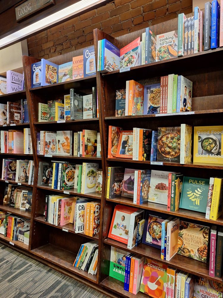 A set of shelves full of cookbooks.