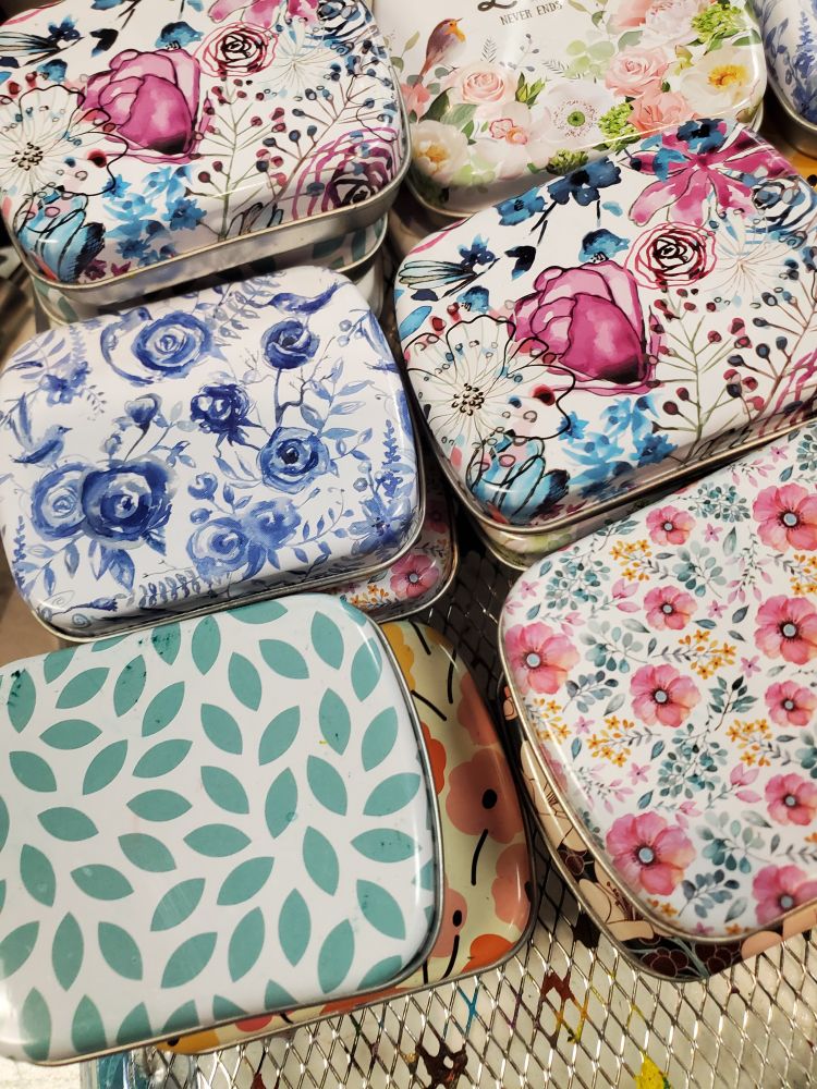 Colorful floral designs on mini tins.