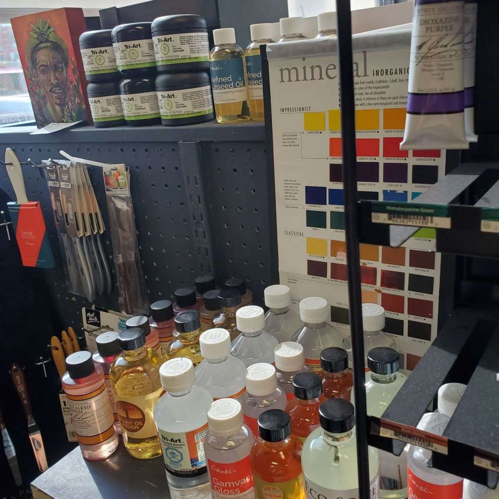 Shelf full of various varnish and mediums for oil painting, lookin' nice in the morning light.