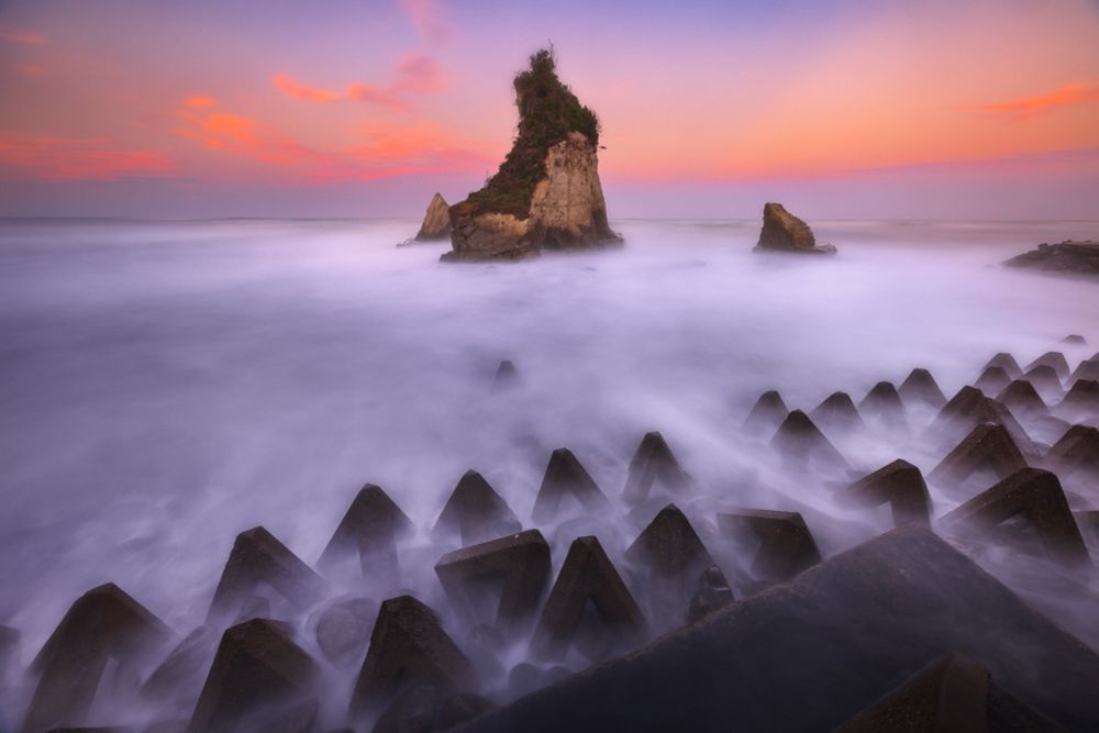 There are several Meoto Iwa rock formations along Japan's coast (couple rock) This version is on the east coast of the Chiba Peninsula near Isumi. I would normally get to sea level, but the high tide and swell from a recent typhoon kept me well away from the crashing waves! The triangular objects are tetrapods aimed to reduce coastal erosion.

