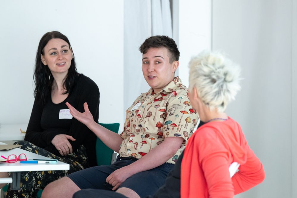 Three people sat talking. 