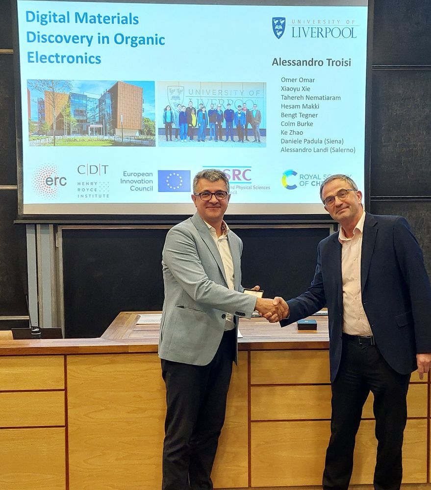 Prof Troisi (left) shaking hands with Prof O'Hagan (right) after receiving the RSC Tilden Prize for Chemistry medal.