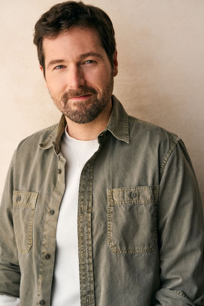 Kyle in a white shirt with a green buttondown