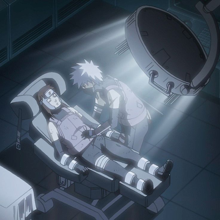 Pre-ANBU Yamato is strapped on to a medical chair, an artificial light directly above him. ANBU Kakashi is standing by his side, one hand on his abdomen