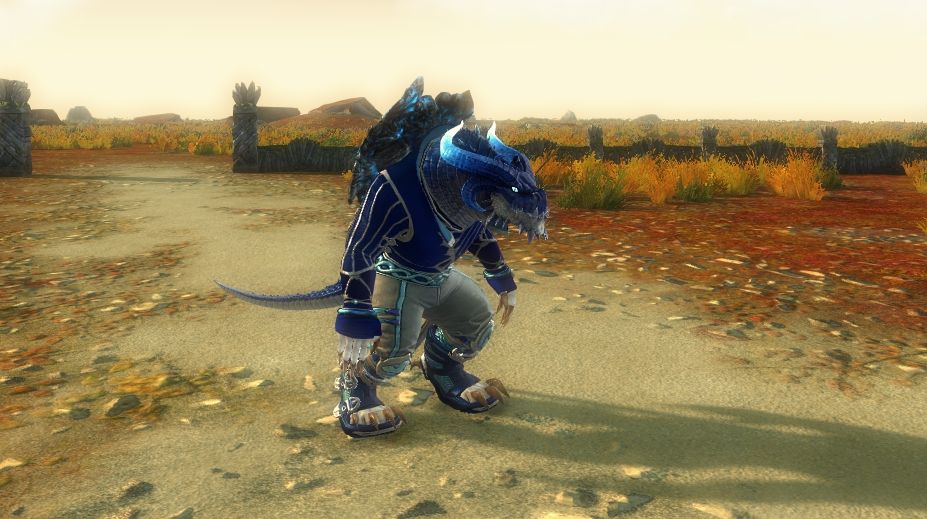 In this one he's wearing a dragon head that makes him completely look like an anthro dragon. On his top he's wearing what suits to be a more formal shirt, if it was designed by a wizard. He's wearing somewhat regular trousers but it has a dragon trail coming out the back infrared of his regular tail. The top and boots are blue with a white trim. His trousers are white with a blue trim. His dragon scales are blue but the chin and front of neck are white and the horns fade from dark blue to glowing light blue.