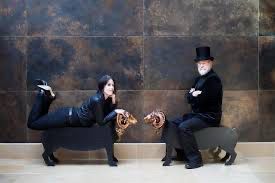 Terry and Rhianna Pratchett sitting on ornamental rams.