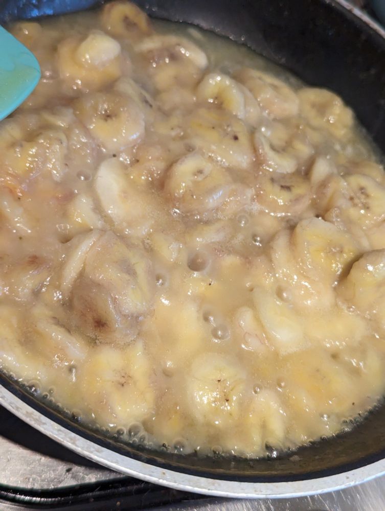 VERY wet bananas frying in a skillet
