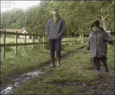 a man and a woman are walking down a muddy path and the website 4gifs.com is visible in the corner