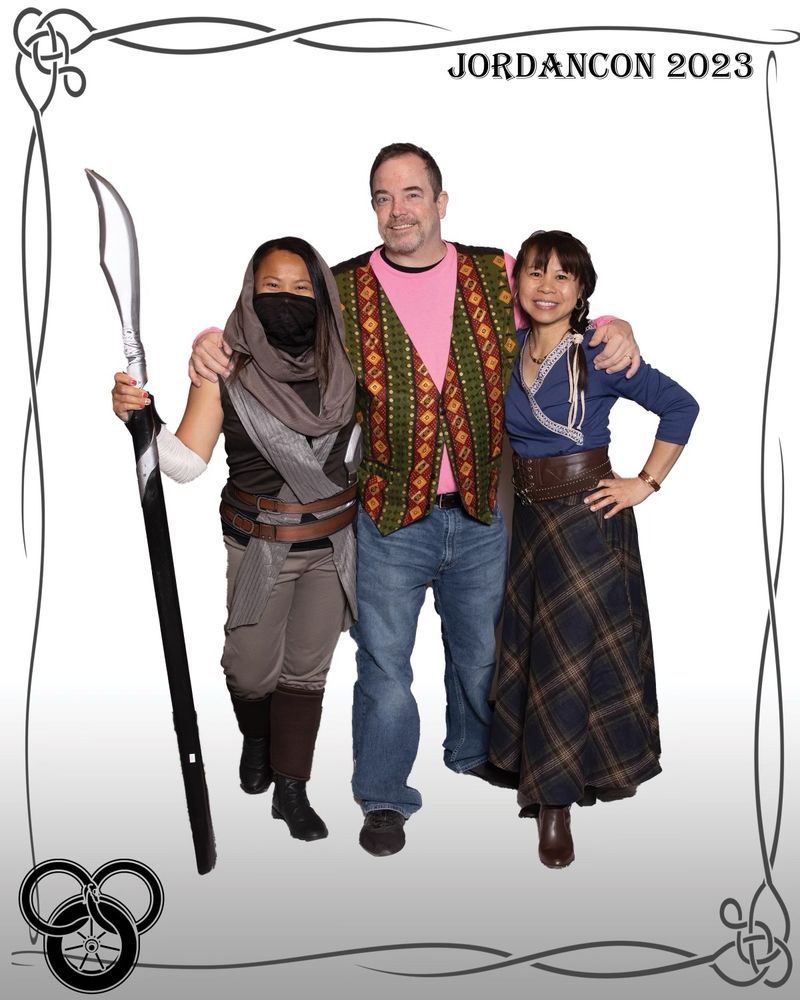 On the left is my sister in an Aiel costume black veil raised holding a spear. Husband in the middle as a Tinker, and myself to the right hand on my hip and wearing a Two Rivers costume.