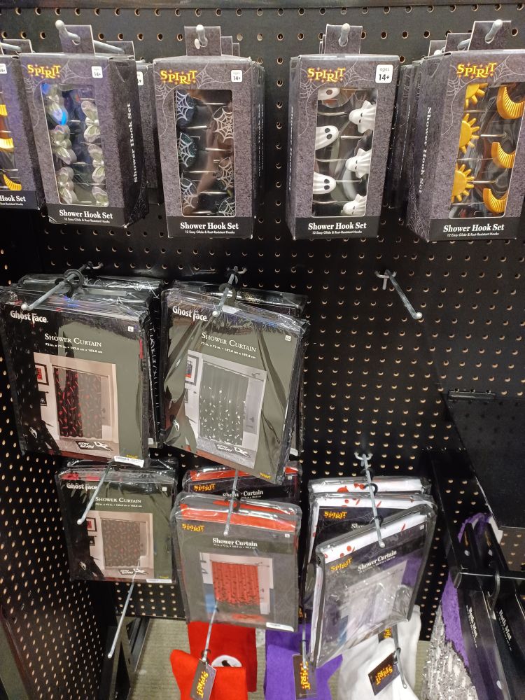 A bunch of spooky gothy shower rings and shower curtains