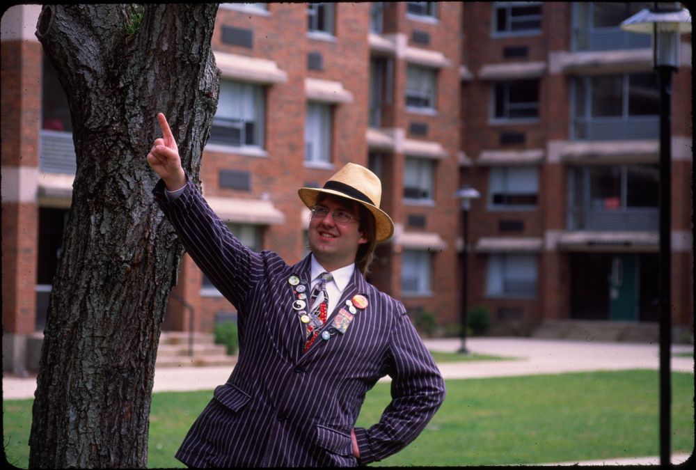 A goofy looking guy with a striped jacket, a Sega tie, and a straw hat.