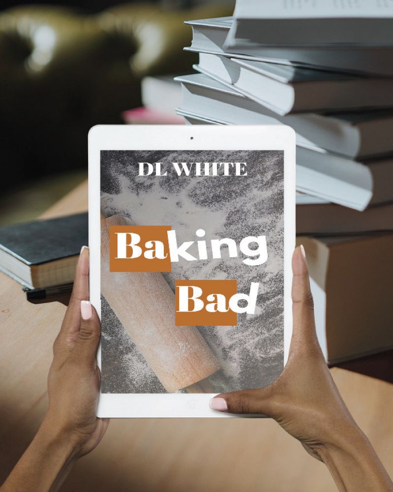 A person holds a tablet displaying the book cover for Baking Bad by DL White. The cover shows a rolling pin dusted with flour on a dark surface, with the title in bold white and orange text. In the background, stacks of books rest on a wooden table.