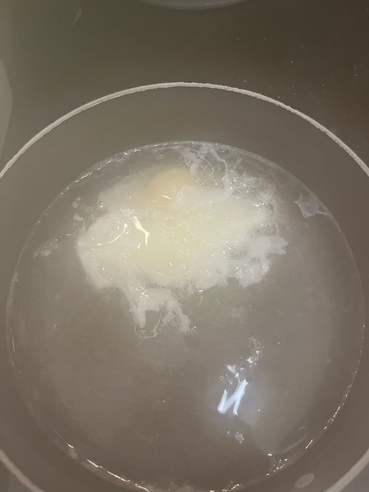 Somewhere in the mists of a boiling pot, an egg is poaching 