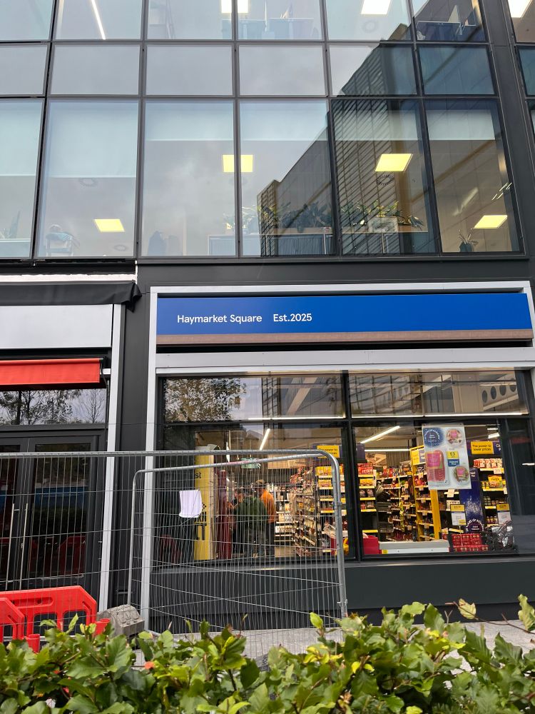 A Tesco bearing the slogan “Haymarket Square, est 2025”
