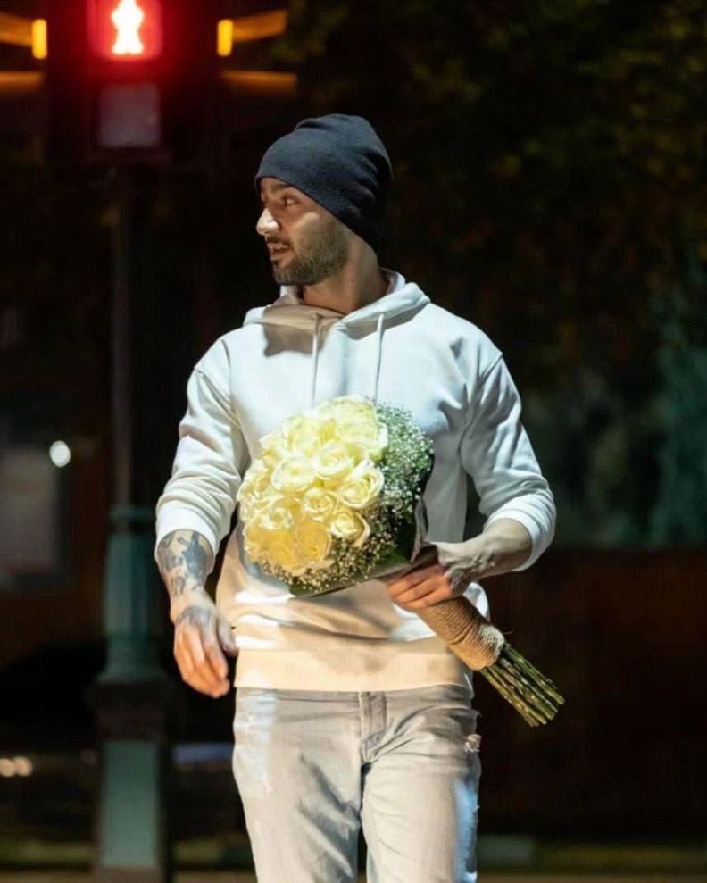 Iranian rapper Toomaj Salehi is released from prison. Seen in photo carrying flowers. 