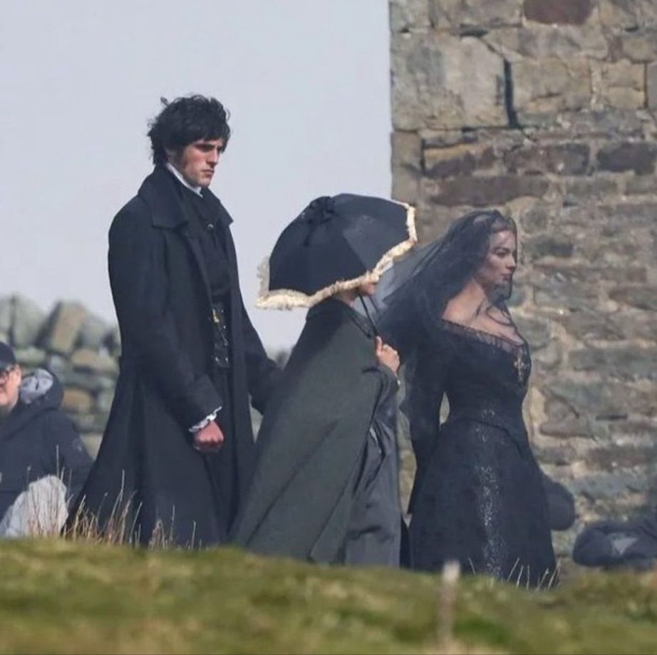 A production still from Emerald Fennel’s upcoming adaptation of Wuthering Heights featuring Jacob Elordi and Margot Robbie in very cheap-looking historically inaccurate costumes.