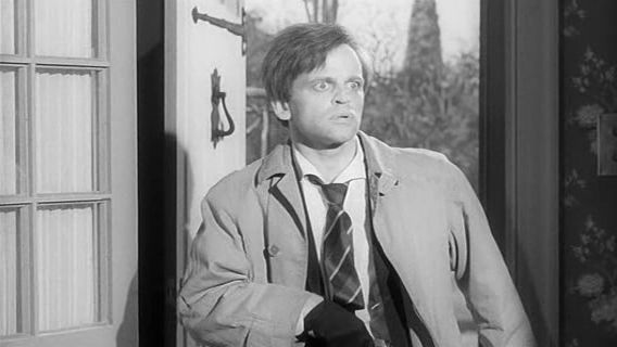 Photo of a wide-eyed Klaus Kinksi standing in a doorway