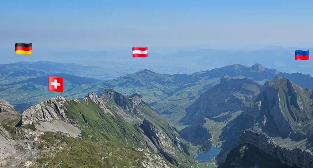 Panoramic view from Mount Säntis towards Lake Constance in the North and the Rhine Valley in the East, the flags of Germany, Austria and Liechtenstein mark the neighbouring countries visible from the spot, the flag of Switzerland in the front the country the picture was taken in.