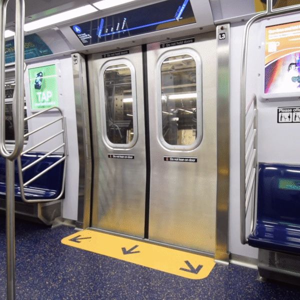 Door of a subway seen from the inside closing automatically with a flashing red light