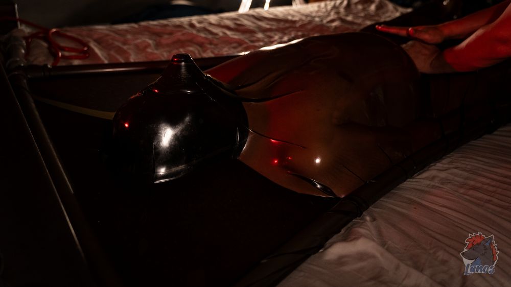 These guys knew exactly how to handle me, and they did a phenomenal job.

After 90 minutes in the Vacbed, I was completely exhausted. When they finally let me out, I was drenched in sweat, my skin flushed red from the tight latex.

It had been intense, probably the most intense scene I’ve ever had, but I was happy beyond words.

I knew I had just experienced something unforgettable.

My friends took good care of me afterward, made sure I was warm and keeping hydrated, gently rubbed down my arms and legs, checked in with me, smiled.

Since it was already after midnight, we had to call it a night.

But that evening, I had met two amazing people thanks to Berk.

And I knew, deep down, I’d be back again… if they’d have me.

And next time?
Maybe they’ll keep me in even longer.
I know I’d do the same for them.