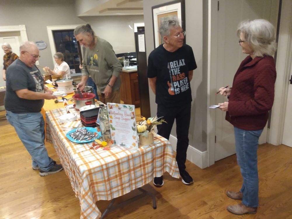 Paula Mohr talking with Kurt Mielke by the serving line at the Bentonsport Stone House.