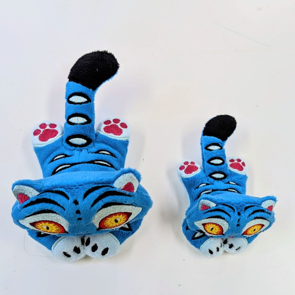 Top down photo of the Derpy the tiger plushies to show the back stripes and size difference. 