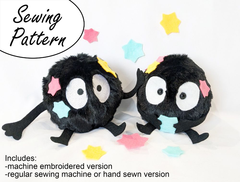 photo of two handmade Soot Sprite plushies. They're made with fuzzy faux fur and they have colorful star candy accessories. 