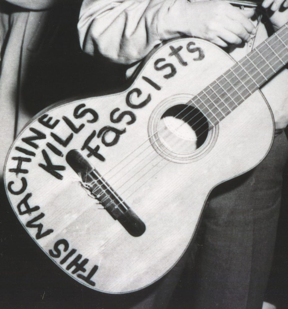 Woodie Guthrie's guitar with the inscription: This machine kills fascists.
