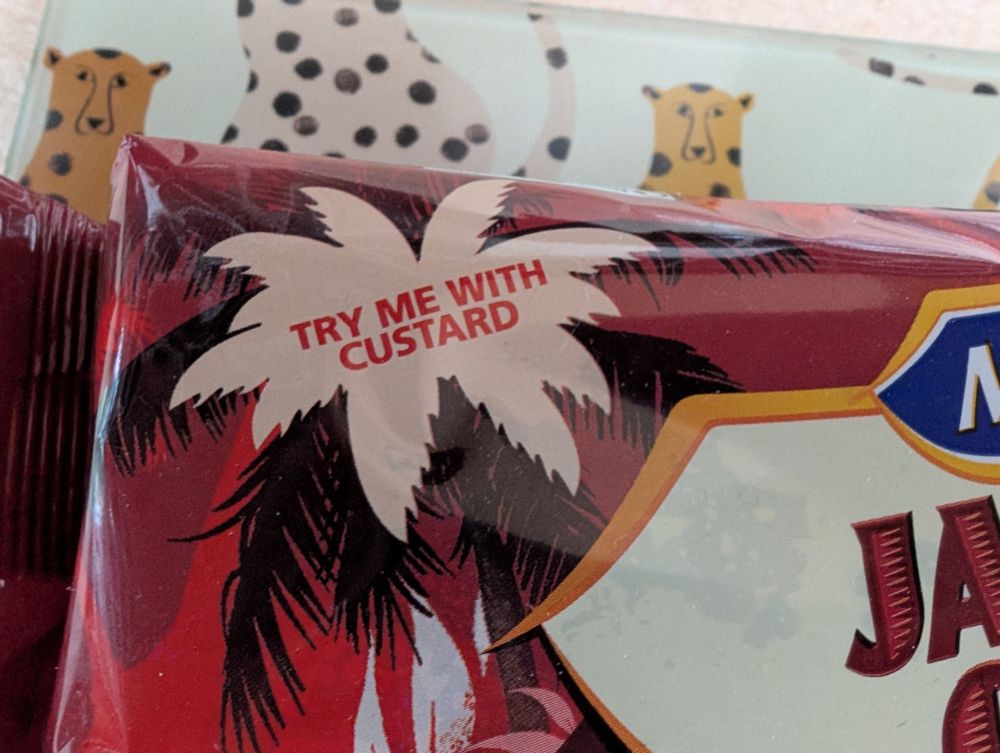 Corner sticker on cake says 'try me with custard'