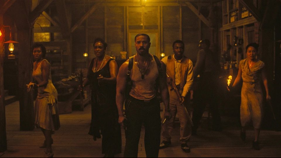 Still shot from Ryan Coogler's film, "Sinners," of Michael B. Jordan and other cast members getting ready to fight.