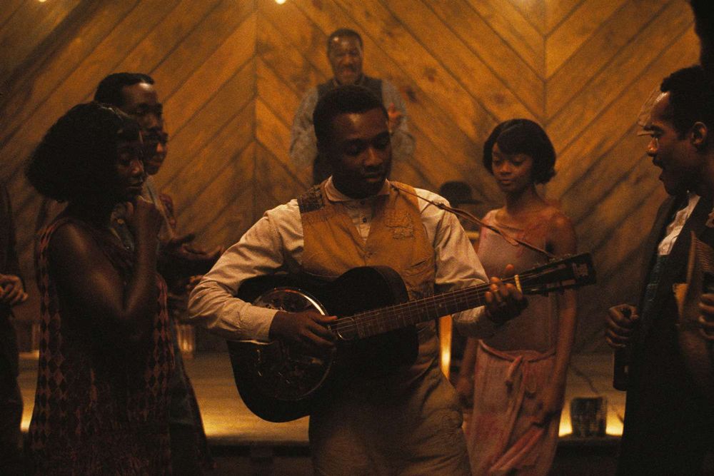 Image from a scene in Ryan Coogler's film, "Sinners," that centers on actor Miles Caton as he begins his guitar-focused song.
