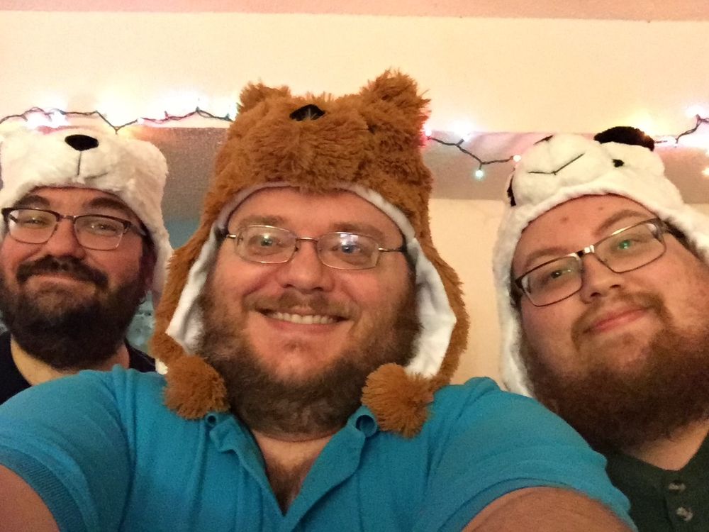 Selfie of 3 bearish men, all wearing bear-shaped winter hats