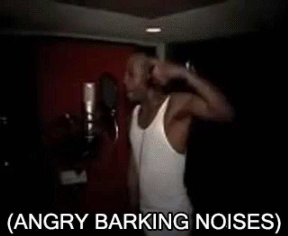 a man in a white tank top is singing into a microphone with the words angry barking noises below him