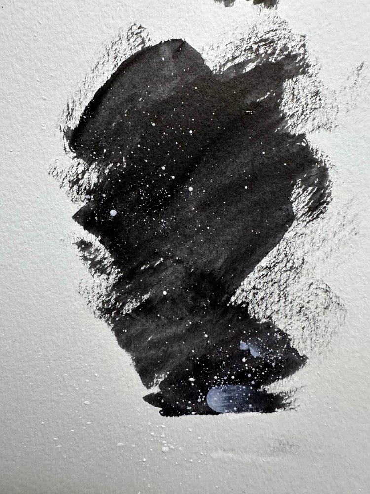 Brushed ink background with splattered white acrylic paint. It appears as a window into a star field with cosmic dust clouding the void of space. 