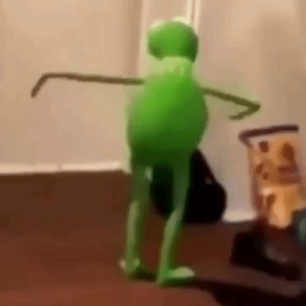 kermit the frog is dancing in a living room .