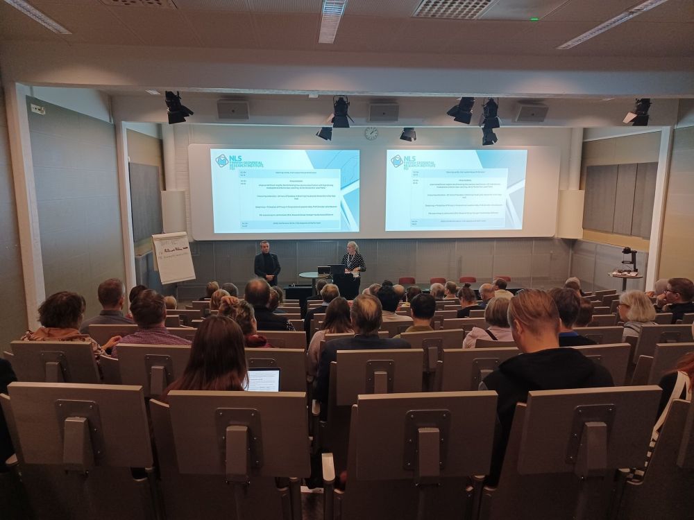Director Jarkko Koskinen opening a presentation series in the auditorium. Seen from the back row of the room.