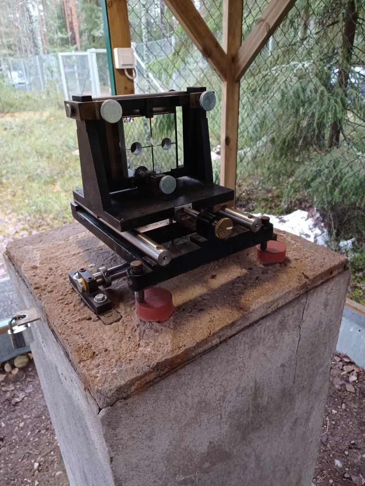 Mirror installed on concrete pillar. Outside in forest under a roof.