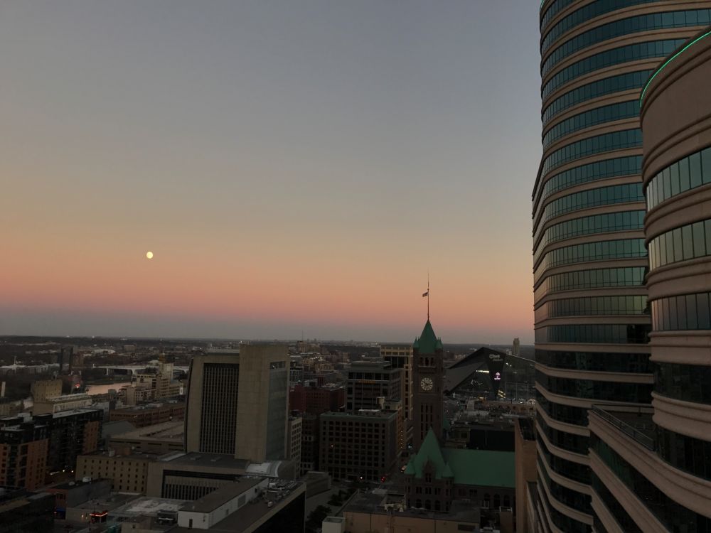 Moonrise over Minneapolis. To the right of the frame is Fifth Street Towers. Central is the Minneapolis City Hall and Justice Center. To the left is the mill district and Mississippi River.