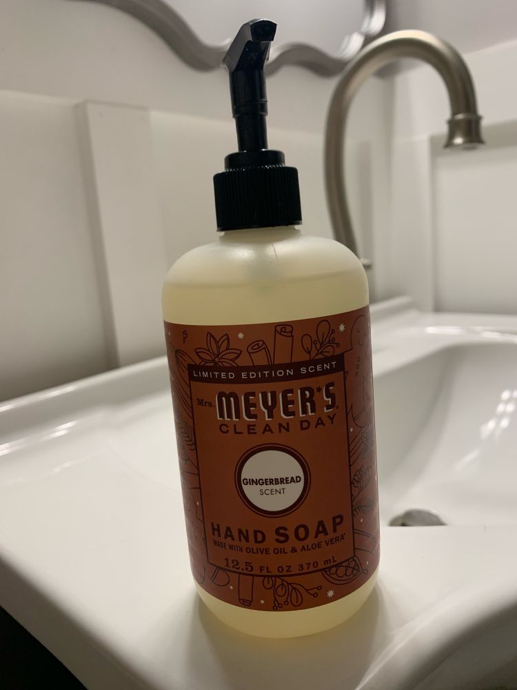 Gingerbread soap dispenser on a bathroom sink. 